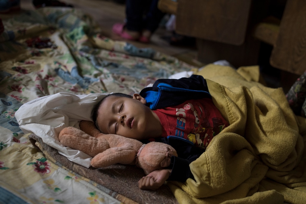 (AP Photo/Hans-Maximo Musielik) A Central American child who is traveling with a caravan of migrants sleeps at a shelter in Tijuana, Mexico, Sunday, April 29, 2018. U.S. immigration lawyers are telling Central Americans in a caravan of asylum-seekers that traveled through Mexico to the border with San Diego that they face possible separation from their children and detention for many months. They say they want to prepare them for the worst possible outcome.