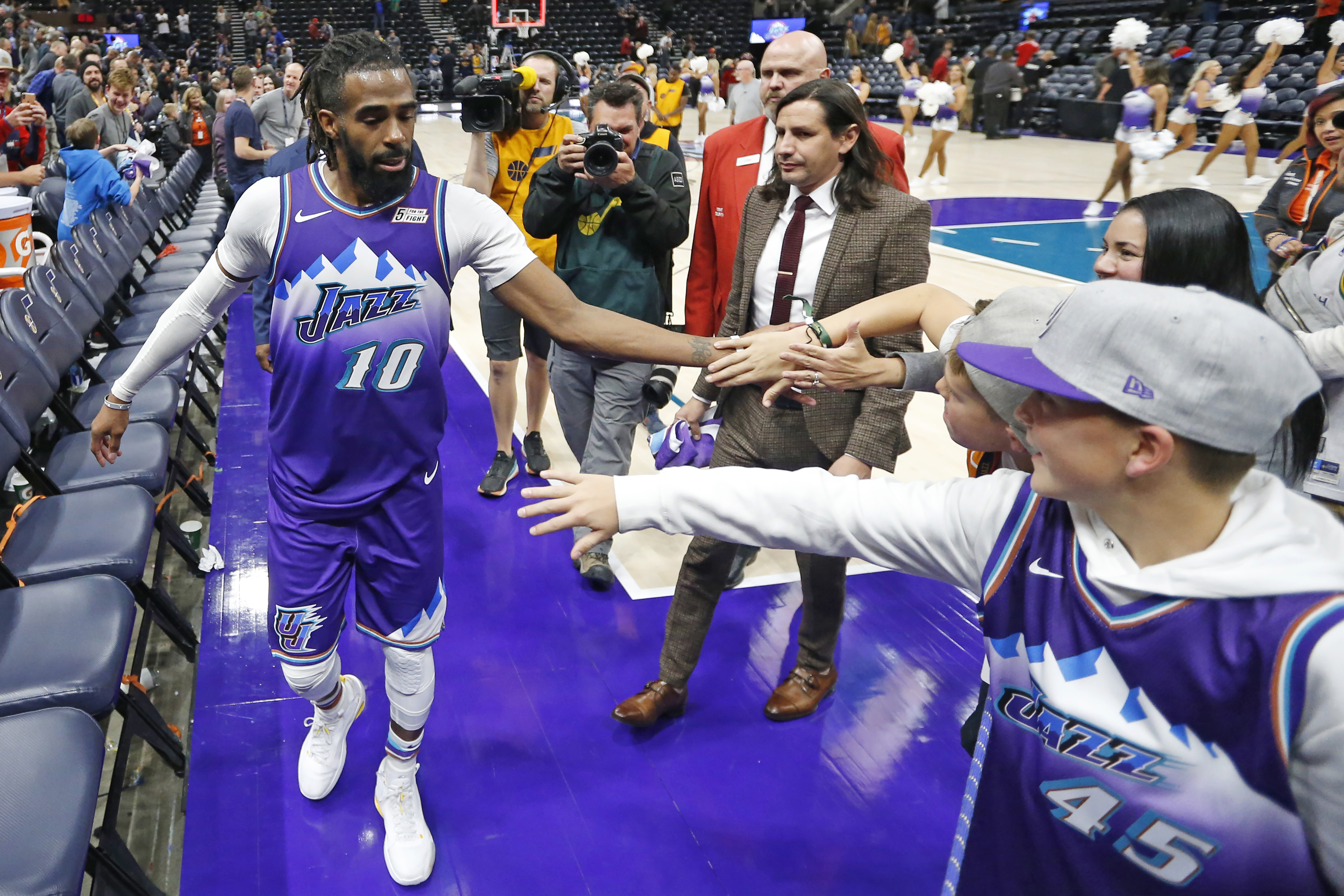 (Rick Bowmer | AP)  Utah Jazz guard Mike Conley receives high-fives from fans as he leaves the court following the team's NBA basketball game against the Los Angeles Clippers on Wednesday, Oct. 30, 2019, in Salt Lake City.