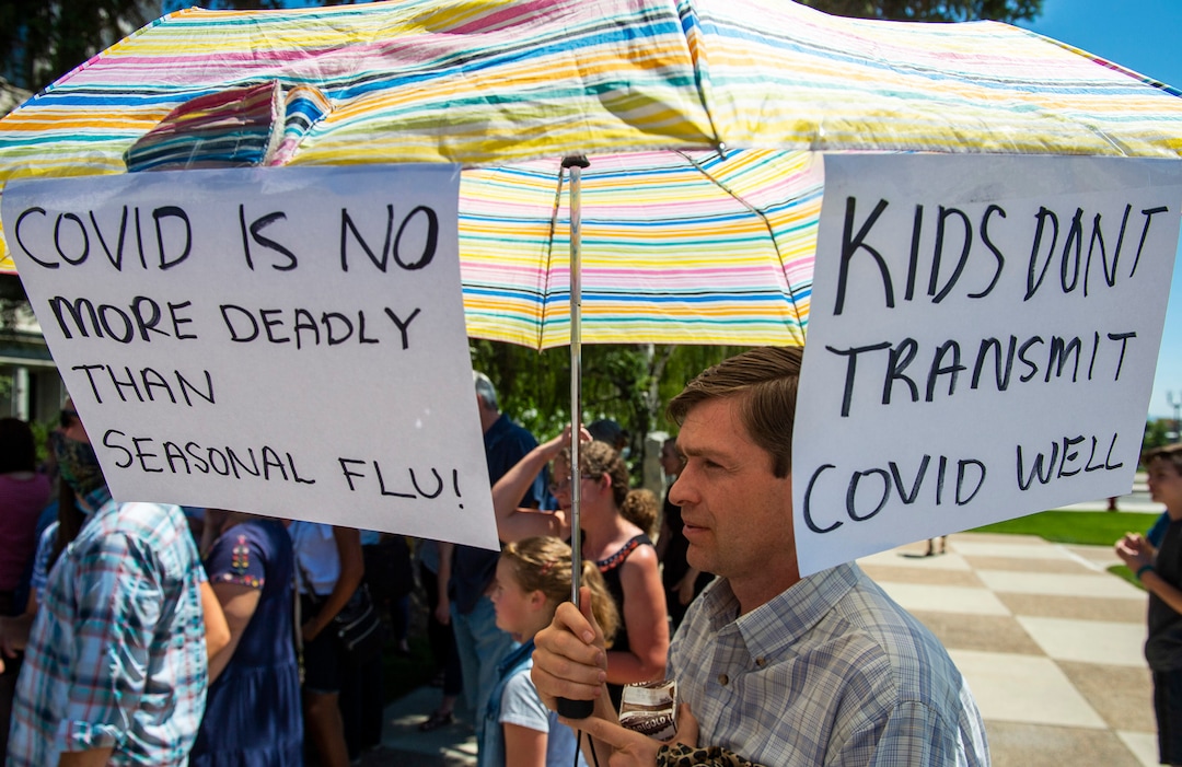 (Rick Egan  |  The Salt Lake Tribune)    Residents gather for a rally protesting against masks being required in schools, before the Utah County Commission meeting in Provo, on Wednesday, July 15, 2020.