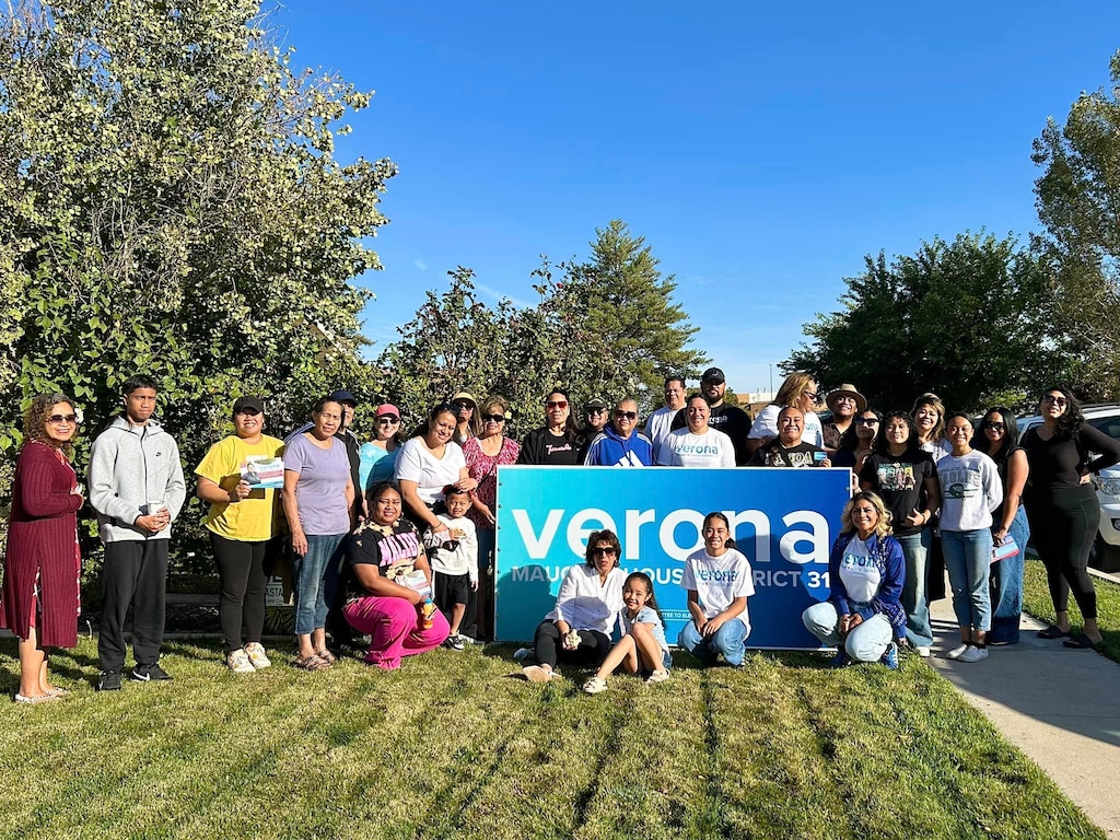 (Verona Mauga) Verona Mauga, who is running to represent Utah House District 31, poses with a campaign sign.