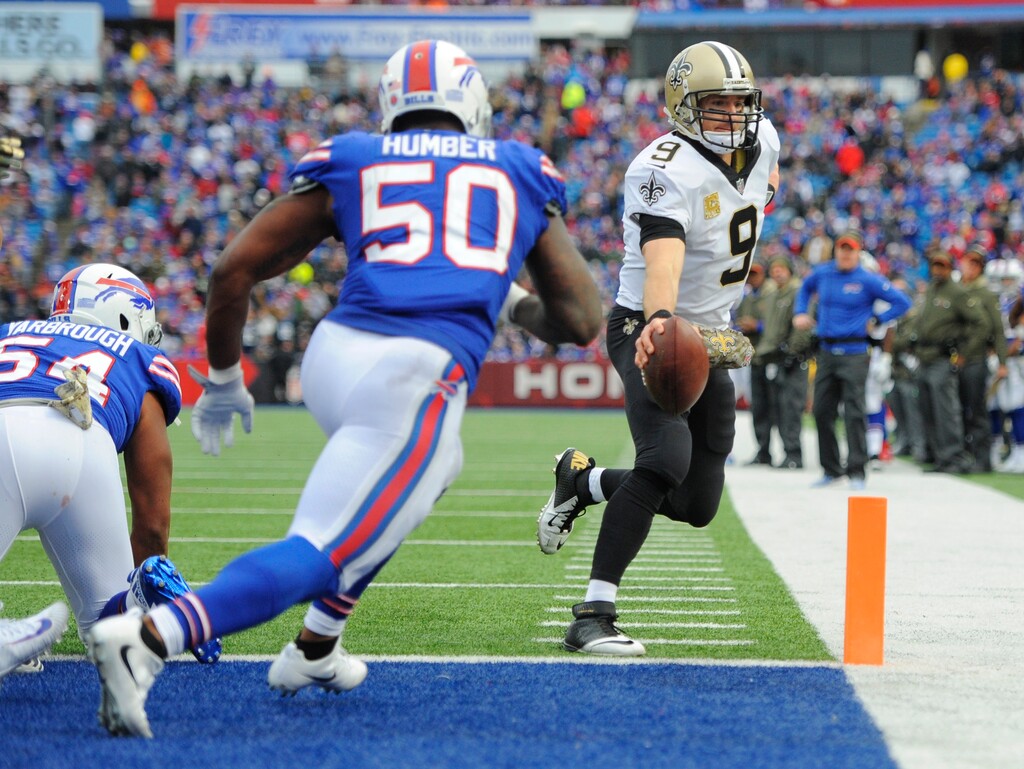 New Orleans Saints quarterback Drew Brees (9) rushes for a touchdown as Buffalo Bills' Ramon Humber (50) closes in during the second half of an NFL football game Sunday, Nov. 12, 2017, in Orchard Park, N.Y. (AP Photo/Adrian Kraus)
