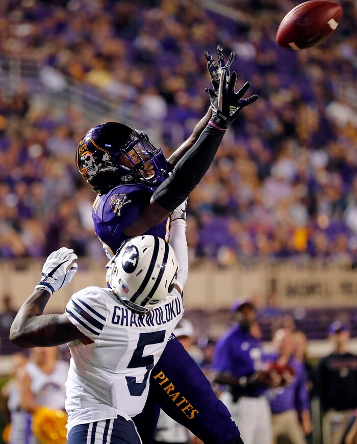 East Carolina's Trevon Brown (88) attempts to pull in the pass over BYU's Dayan Ghanwoloku (5) during the second half of an NCAA college football game in Greenville, N.C., Saturday, Oct. 21, 2017. (AP Photo/Karl B DeBlaker)