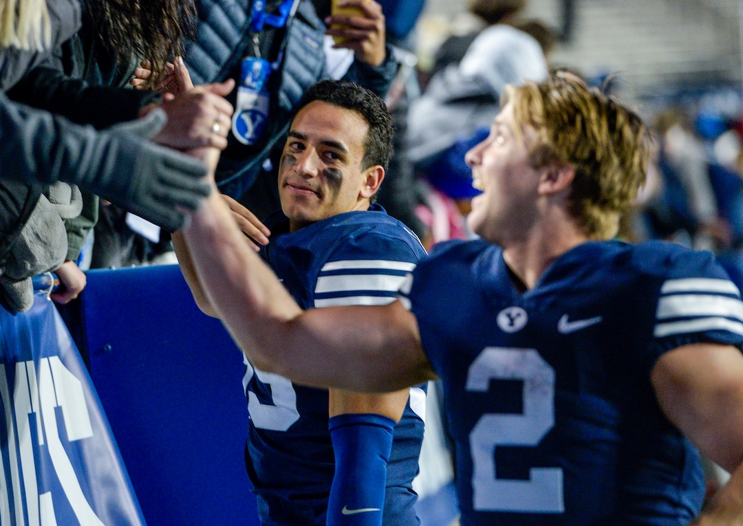 Leah Hogsten  |  The Salt Lake Tribune  l-r Brigham Young Cougars linebacker Isaiah Kaufusi (53) and Brigham Young Cougars running back Matt Hadley (2) celebrate the win with fans over Hawaii at Lavell Edwards Stadium in Provo, Saturday Oct. 13, 2018. BYU defeated Hawaii 49-23.