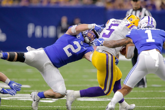 BYU linebacker Matt Hadley and defensive back Troy Warner (1) tackle LSU running back Derrius Guice (5) in the second half of an NCAA college football game in New Orleans, Saturday, Sept. 2, 2017. (AP Photo/Scott Threlkeld)
