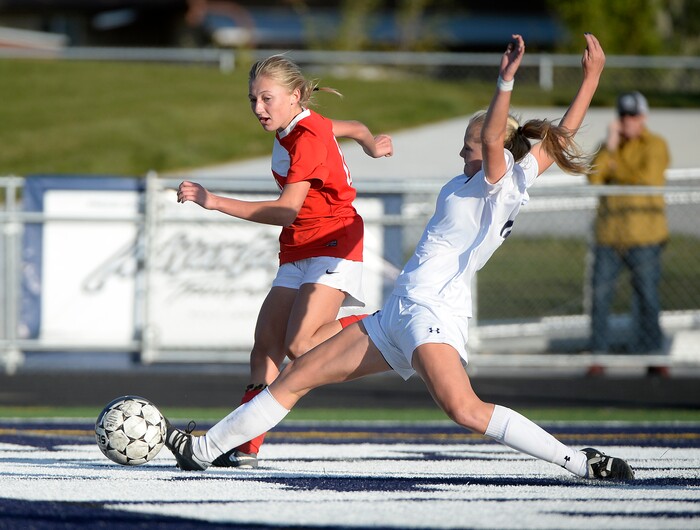 (Scott Sommerdorf   |  The Salt Lake Tribune)   East forward Emily Jensen gets this shot past Corner Canyon's Emily Boyce for a goal during second half play. East beat Corner Canyon 4-1 in a Class 5A girls' soccer state quarterfinal, Thursday, October 12, 2017. 