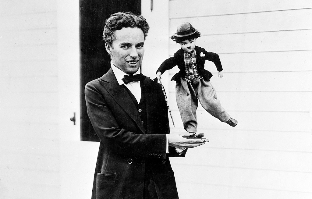 (AP file photo) In this 1917 photo Charlie Chaplin holds a puppet doll of the Tramp in Hollywood, Calif. Edison Street Events is streaming short films by Chaplin from 1916 and 1917, with organ accompaniment by Blaine Gale, to audiences stuck at home during the coronavirus outbreak.