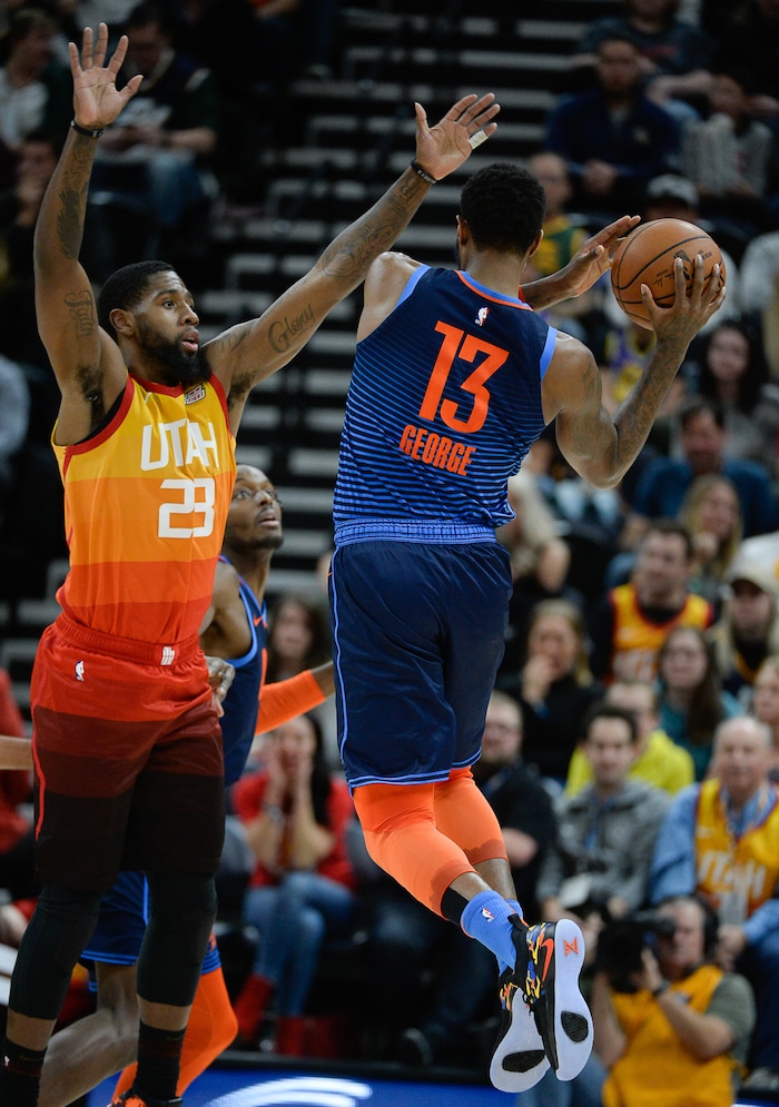 (Francisco Kjolseth  |  The Salt Lake Tribune)   Utah Jazz forward Royce O'Neale (23) tries to block Oklahoma City Thunder forward Paul George (13) in the NBA game at Vivint Smart Home Arena Sat., Dec. 22, 2018, in Salt Lake City.
