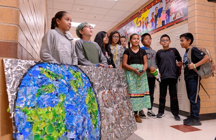 (Leah Hogsten  |  The Salt Lake Tribune) Students at Parkview Elementary have created a treasure with trash. Ten fifth graders in Cher Sten’s extended learning program or ELP class, molded school and household plastic refuse into a mosaic to send the message— “Consume Less” to their classmates. The idea for the mural began after a discussion about global warming, climate issues, plastic pollution and its implications on earth.