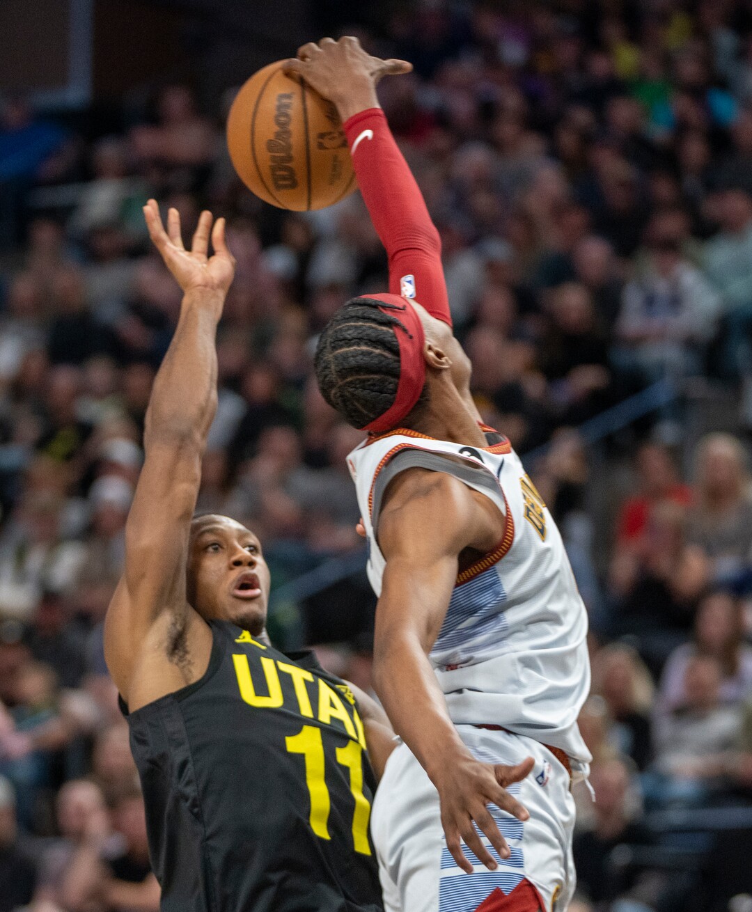 (Rick Egan | The Salt Lake Tribune) Denver Nuggets forward Peyton Watson (8) blocks a shot by Utah Jazz guard Kris Dunn (11), in NBA action between the Utah Jazz and the Denver Nuggets at Vivint Arena,  Saturday, April 8, 2023.