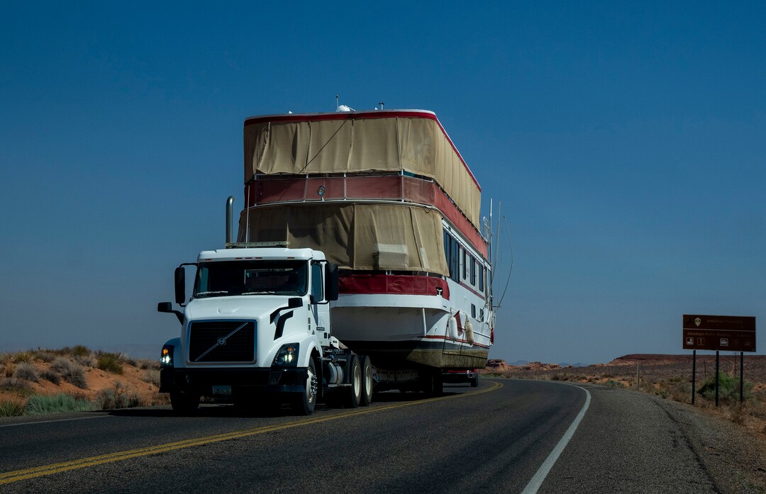 (Rick Egan | The Salt Lake Tribune)  A truck pulls a house boat up the road near Wahweap Marina, atLake Powell, on Tuesday, Aug. 3, 2021.