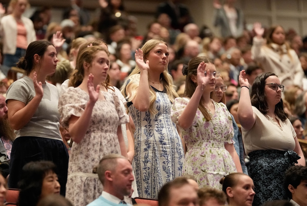 (Francisco Kjolseth | The Salt Lake Tribune) Young Latter-day Saint women stand to sustain President Dallin H. Oaks and the First Presidency during a solemn assembly in April. New research shows more are more likely to leave the faith than men.