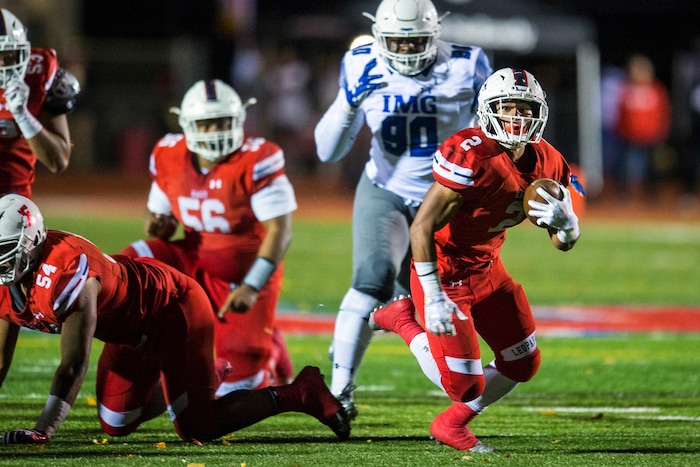 (Chris Detrick  |  The Salt Lake Tribune)  East's Sione Molisi (2) runs past IMG Academy's Stephon Wynn Jr. (90) during the game at East High School Friday, October 20, 2017. 