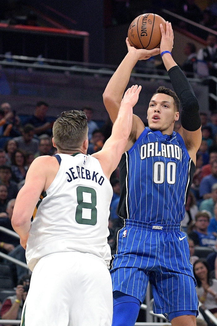 Orlando Magic forward Aaron Gordon (00) goes up for a shot in front of Utah Jazz forward Jonas Jerebko (8) during the first half of an NBA basketball game, Saturday, Nov. 18, 2017, in Orlando, Fla. (AP Photo/Phelan M. Ebenhack)
