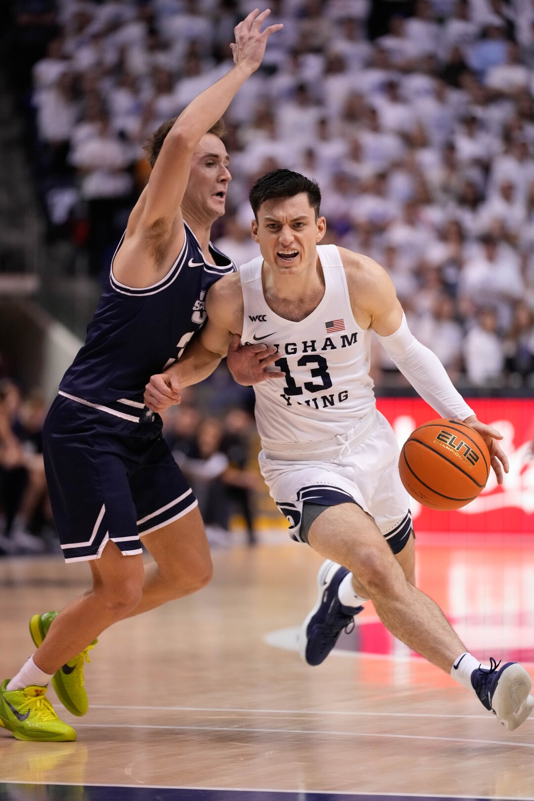 (Francisco Kjolseth | The Salt Lake Tribune) Brigham Young Cougars guard Alex Barcello (13) is pressured by Utah State Aggies guard Steven Ashworth (3) in basketball action between the Brigham Young Cougars and the Utah State Aggies at the Marriott Center in Provo, Wednesday, Dec. 8, 2021.