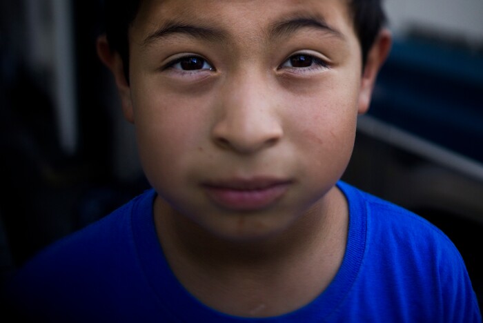 (Jae C. Hong | The Associated Press) John Ruiz, 9, poses for a photo in front of the RV where he lives with his family on Monday, Oct. 23, 2017, in Mountain View, Calif. His parents and four siblings moved into the camper after they could no longer afford the rent in an apartment. John dreams of his family having a successful life together and maybe ending up in mansion _ a home that might have swimming pool and backyard. Or at least one big enough to have his own room.