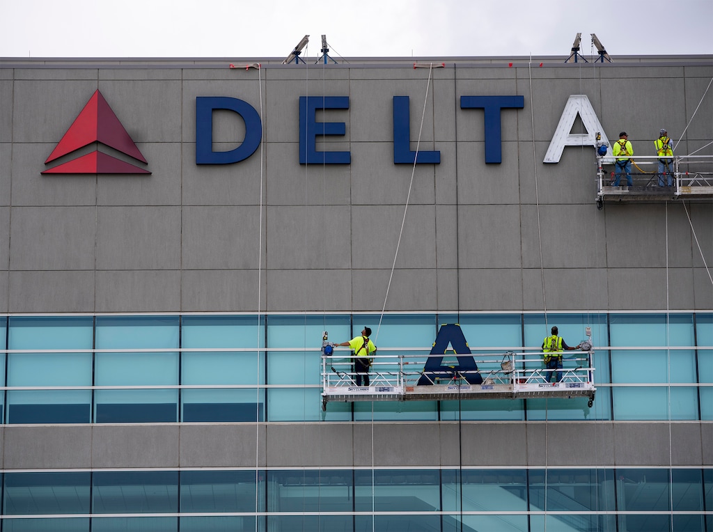 (Rick Egan | The Salt Lake Tribune)  Workers put the the Delta logo back on the Utah Jazz's downtown arena, on Thursday, May 25, 2023.