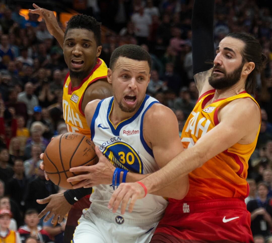 (Rick Egan  |  The Salt Lake Tribune)  Utah Golden State Warriors guard Stephen Curry (30) squeezes past Utah Jazz guard Donovan Mitchell (45) and Ricky Rubio (3), in NBA action between Utah Jazz and Golden State Warriors, in Salt Lake City, Wednesday, Dec. 19, 2018.