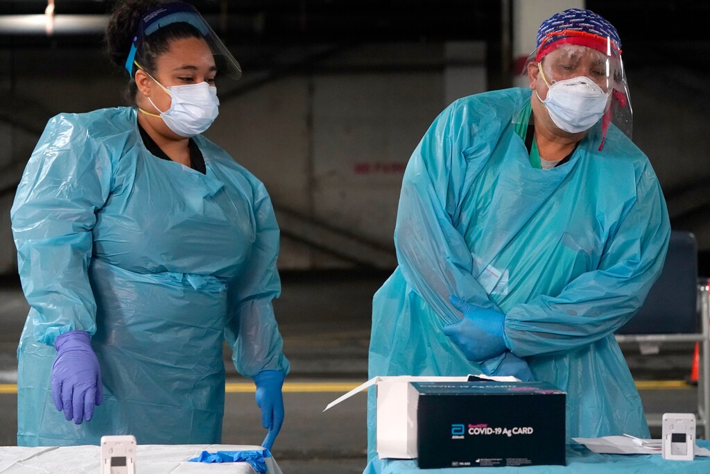 (Seth Wenig | AP) Nurses check on the status of rapid COVID-19 tests at a drive-through testing site in a parking garage in West Nyack, N.Y., Monday, Nov. 30, 2020. The site was only open to students and staff of Rockland County schools in an effort to test enough people to keep the schools open for in-person learning.