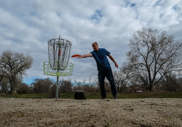 (Francisco Kjolseth  |  The Salt Lake Tribune)  Long time disc golfer Nathan Ottesen of Orem tries out the Roots Disc Golf Course in the Rose Park neighborhood, site of one of the original disc golf courses in Utah before becoming a ball golf course for nearly 20 years. PGA Tour golfer Tony Finau grew up playing the Jordan River Par-3 course that has been converted back to a disc golf venue.