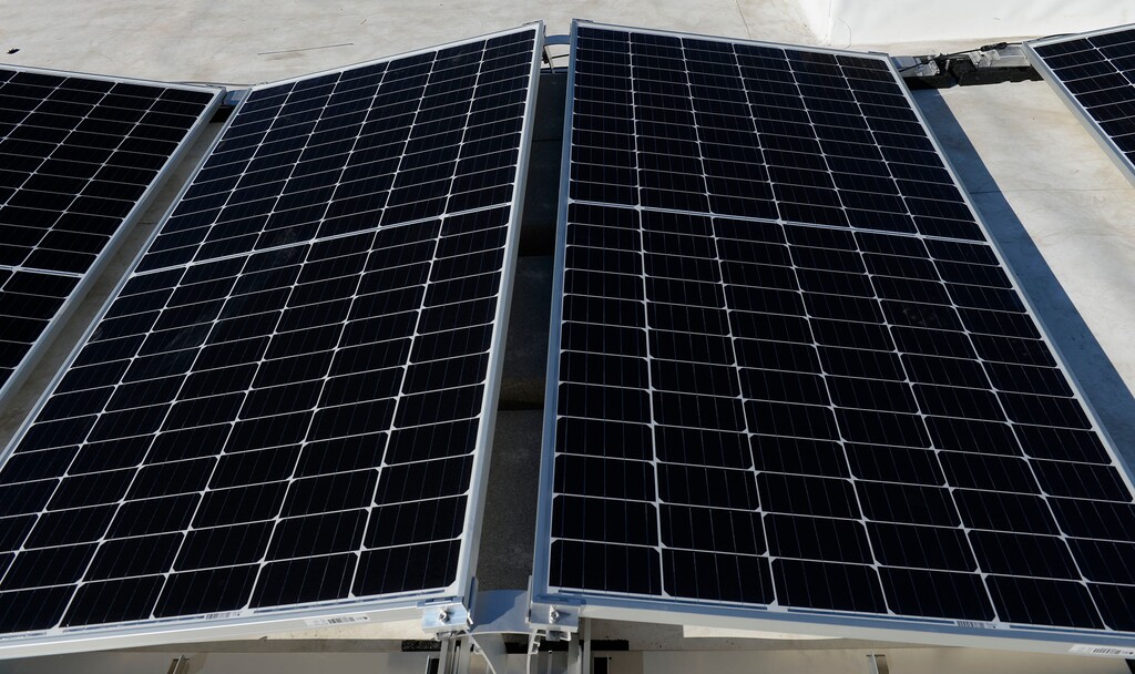 (Leah Hogsten  |  Tribune file photo) Creative Energies solar installation employees install photovoltaic panels on the roof of the Boys and Girls Club in Salt Lake City, March 5, 2020.