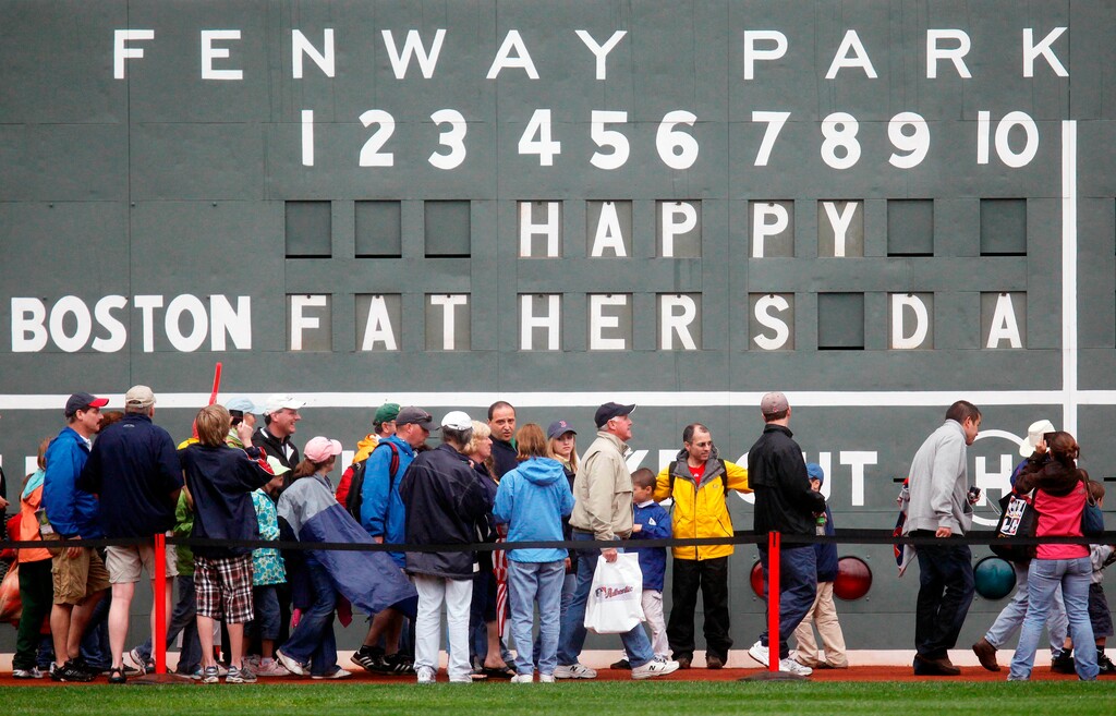 (Michael Dwyer | AP Photo) In this June 21, 2009 file photo, fans tour in front of the scoreboard in Fenway Park in Boston in celebration of Father's Day following a baseball game between the Atlanta Braves and the Boston Red Sox. The U.S. Census Bureau has released a new report showing more than 60% of the 121 million men in the U.S. are fathers. The data in the report released this week of June 15, 2019, comes from 2014 when the bureau for the first time asked both men and women about their fertility histories. The report says just under three-quarters of fathers are married. Almost 13% of dads are divorced and 8% have never been married.
