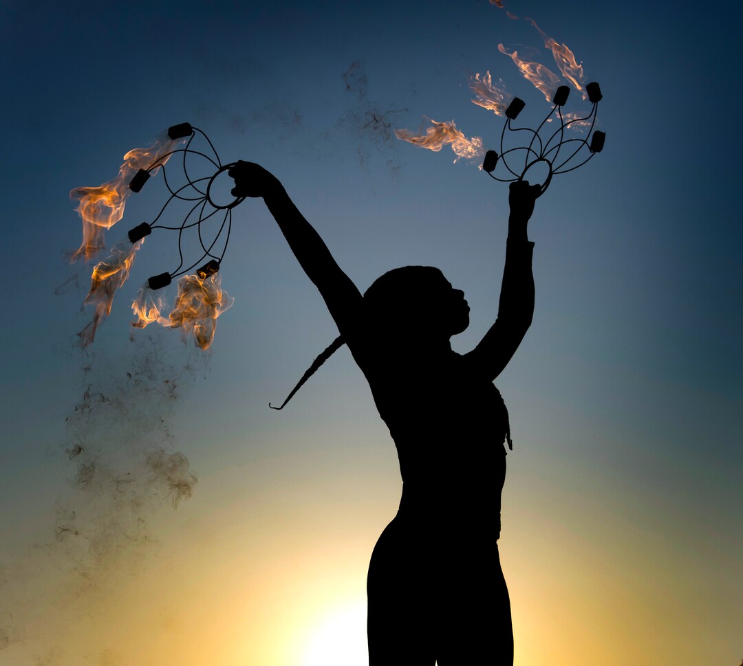 (Rick Egan  |  The Salt Lake Tribune)   Tiana Powell from Rancho Cucamonga dances with fire at sunrise, during Burning Man, in the Black Rock Desert in Nevada, Saturday, Sept. 1, 2018. 