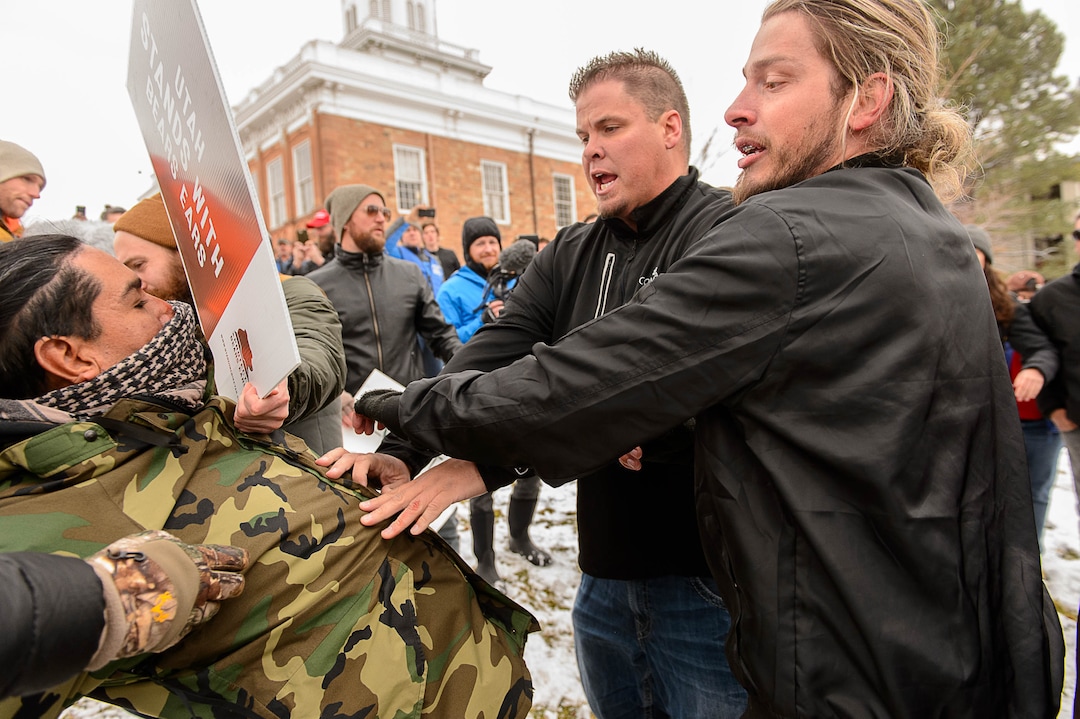 (Trent Nelson | The Salt Lake Tribune)  A protester is pushed back after assaulting a counter-protester during a rally against a visit by President Donald Trump, Monday December 4, 2017.
