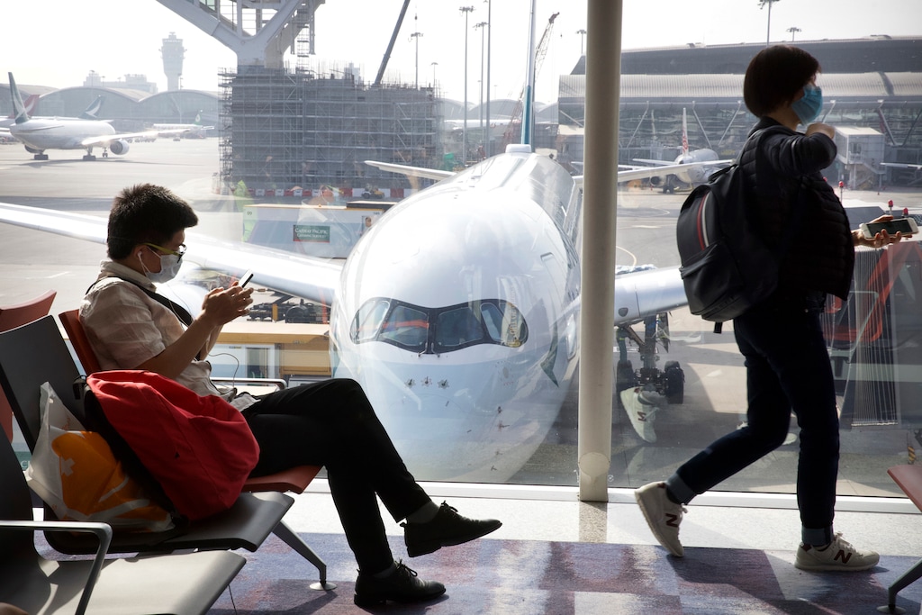 (Ng Han Guan | AP) Travelers wear face masks as they wait their flight at Hong Kong International Airport in Hong Kong, Tuesday, Jan. 21, 2020. Face masks sold out and temperature checks at airports and train stations became the new norm as China strove Tuesday to control the outbreak of a new coronavirus that has reached four other countries and territories and threatens to spread further during the Lunar New Year travel rush.