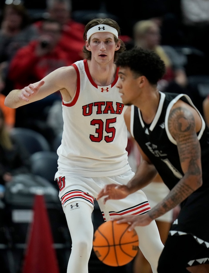 (Bethany Baker  |  The Salt Lake Tribune) Utah Utes center Branden Carlson (35) defends as Hawaii Warriors forward Justin McKoy (1) moves the ball at the Delta Center in Salt Lake City on Thursday, Nov. 30, 2023.