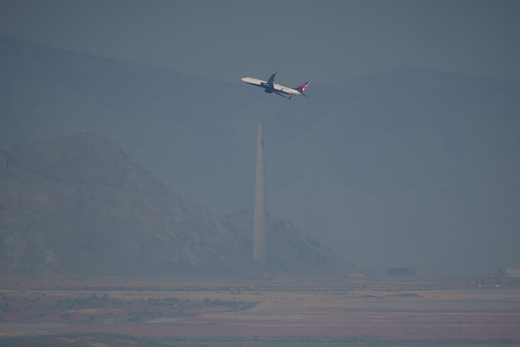 (Trent Nelson  |  The Salt Lake Tribune) A passenger jet takes off in a dusty, hazy Salt Lake Valley in July 2024. The EPA has signaled its intent to revote a "serious" classification for northern Utah's summertime ozone pollution.