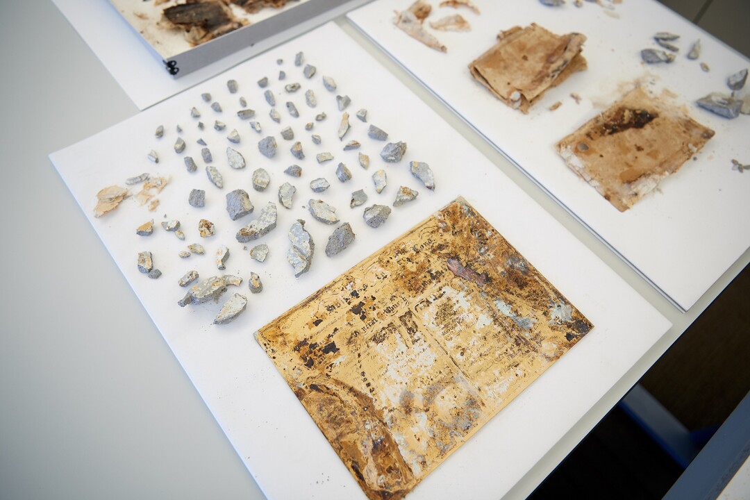 (Photo courtesy of The Church of Jesus Christ of Latter-day Saints) These items are from within the capstone of the Salt Lake Temple. In the foreground, middle, is a copper plate inscribed with the names of the Church General Authorities present for the laying of the temple cornerstone on April 6, 1853, as well as the names of Church General Authorities present at the laying of the capstone on the same date 39 years later.