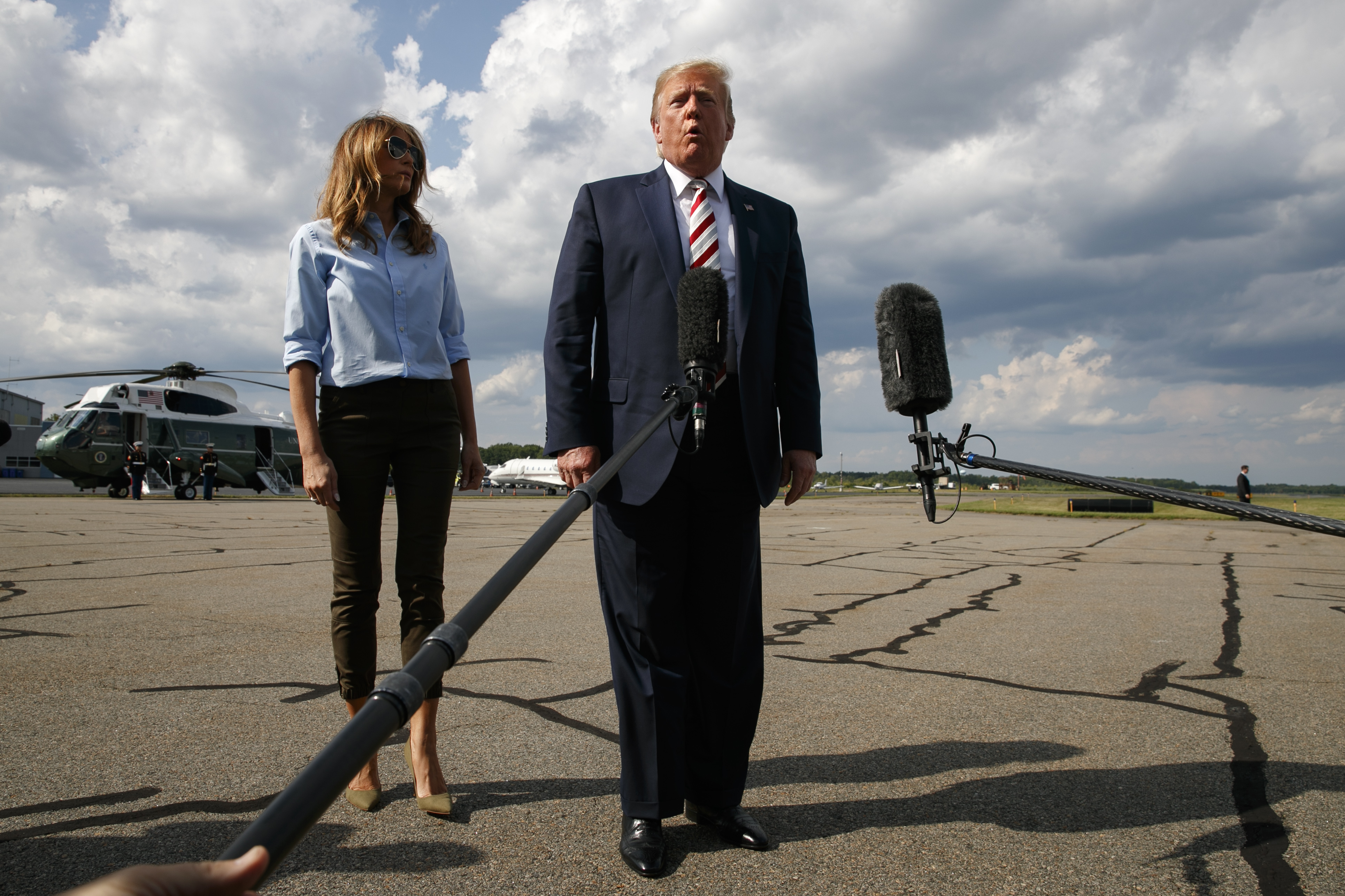 (Jacquelyn Martin | AP Photo) President Donald Trump, with first lady Melania Trump, speaks to the media about the recent mass shootings in El Paso, Texas, and Dayton, Ohio, before boarding Air Force One in Morristown, N.J., Sunday, Aug. 4, 2019, to return to Washington.