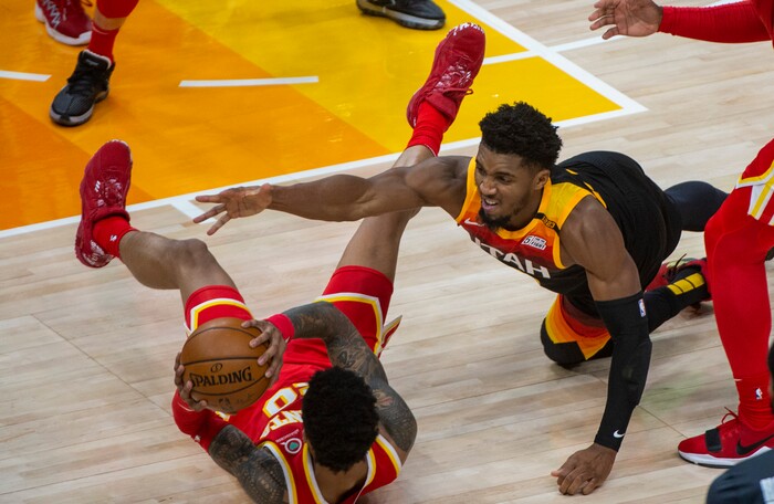 (Rick Egan | The Salt Lake Tribune) Utah Jazz guard Donovan Mitchell (45) dives for a loose ball, along with Atlanta Hawks forward John Collins (20), in NBA action between the Utah Jazz and the Atlanta Hawks at Vivint Arena, on Friday, Jan. 15, 2021.