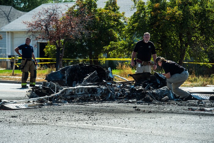 (Chris Detrick  |  The Salt Lake Tribune)  The scene of a plane crash at 1900 West and 4500  South in Roy Tuesday, September 12, 2017. The pilot of a single-engine airplane survived a fiery crash on a street in Roy Tuesday afternoon, authorities said. Roy police Sgt. Matthew Gwynn said the pilot was transported to a hospital “out of precaution,” as was the driver of a car that the plane hit.