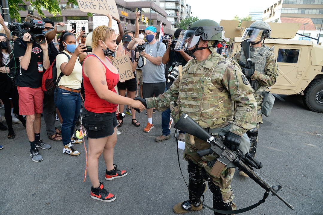 (Francisco Kjolseth  |  The Salt Lake Tribune) Victoria Crosby with Black Lives Matter receives hand shakes from law enforcement as demonstrators protest against police brutality on Tuesday, June 2, 2020, in downtown Salt Lake City, as an 8 p.m. weeklong curfew remains in order.