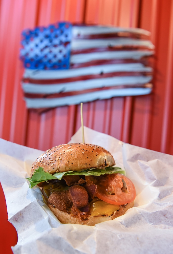 (Francisco Kjolseth | The Salt Lake Tribune) Whiskey-Tango-Foxtrot is loaded, with 1/4 lb hamburger, cheddar cheese, Jack Daniel's whiskey caramalized onions, bacon, lettuce, tomato and private sauce. Special Courses, a military-themed restaurant in the dining terrace at The Shops at South Town in Sandy, specializes in burgers and fries. Staff Sgt. James Veylupek, the owner, got help launching the eatery after winning Taste for the Space in May 2017.