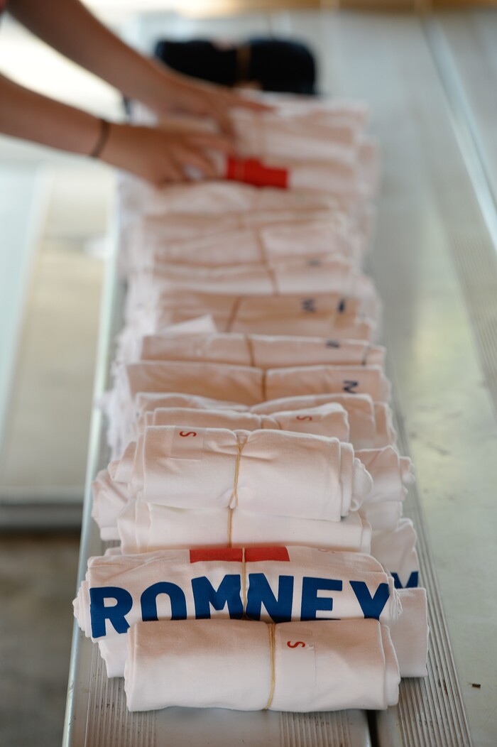 (Francisco Kjolseth | The Salt Lake Tribune) Lining up shirts to give away, the Romney campaign hosts "Mondays With Mitt" at Veterans Memorial Park in West Jordan on Monday, June 18, 2018 as Senate candidate Mitt Romney visits with supporters and takes a few questions from the dozens gathered at the park.