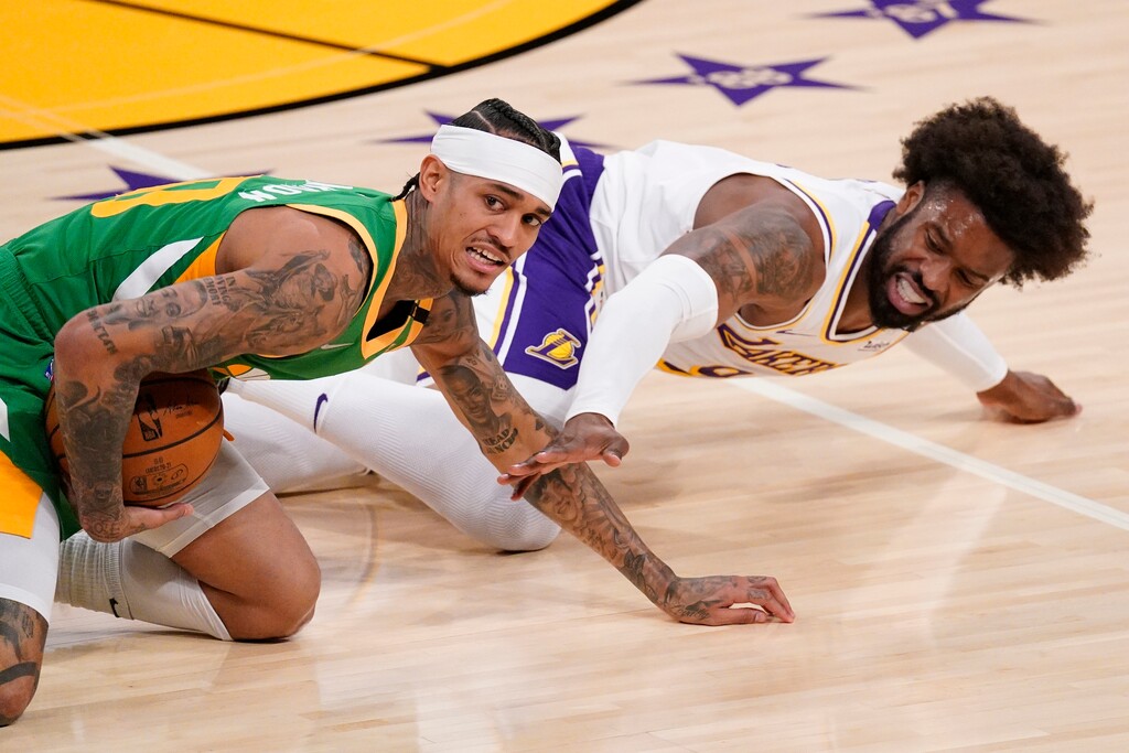 Utah Jazz guard Jordan Clarkson, left, and Los Angeles Lakers guard Wesley Matthews scramble for a loose ball during the first half of an NBA basketball game Saturday, April 17, 2021, in Los Angeles. (AP Photo/Mark J. Terrill)