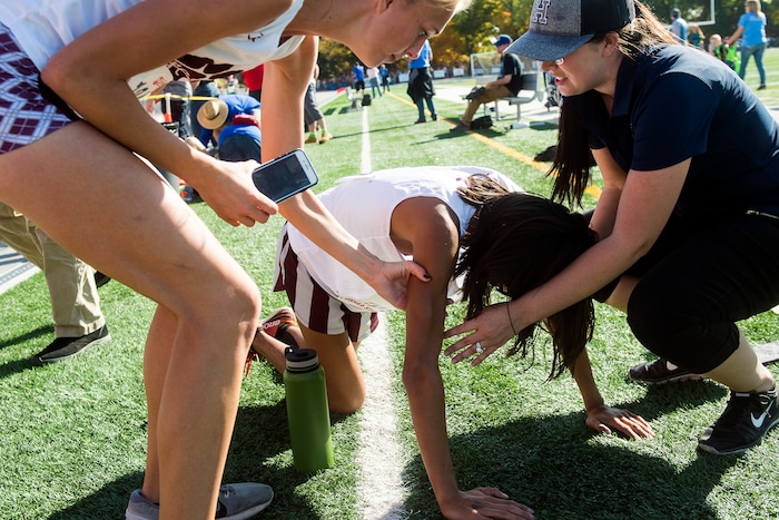 (Chris Detrick  |  The Salt Lake Tribune)  Pine View junior Julien Canales is helped after competing in the 4A boy's state cross-country meet at Sugar House Park and Highland High School Wednesday, October 18, 2017. 