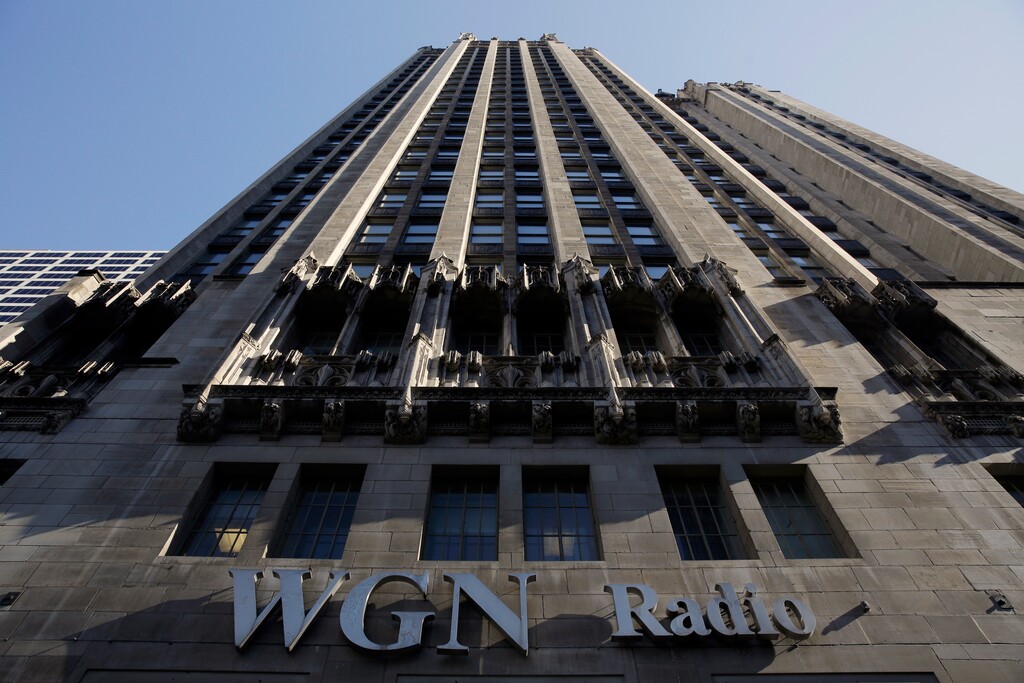 (Kiichiro Sato | The Associated Press) In this Monday, May 1, 2017, file photo, the WGN Radio sign appears on the side of Tribune Tower, in downtown Chicago. Sinclair Broadcast Group, one of the nation's largest local TV station operators, announced Monday, May 8, 2017, that it will pay about $3.9 billion for Tribune Media, adding more than 40 stations including KTLA in Los Angeles, WPIX in New York and WGN in Chicago.