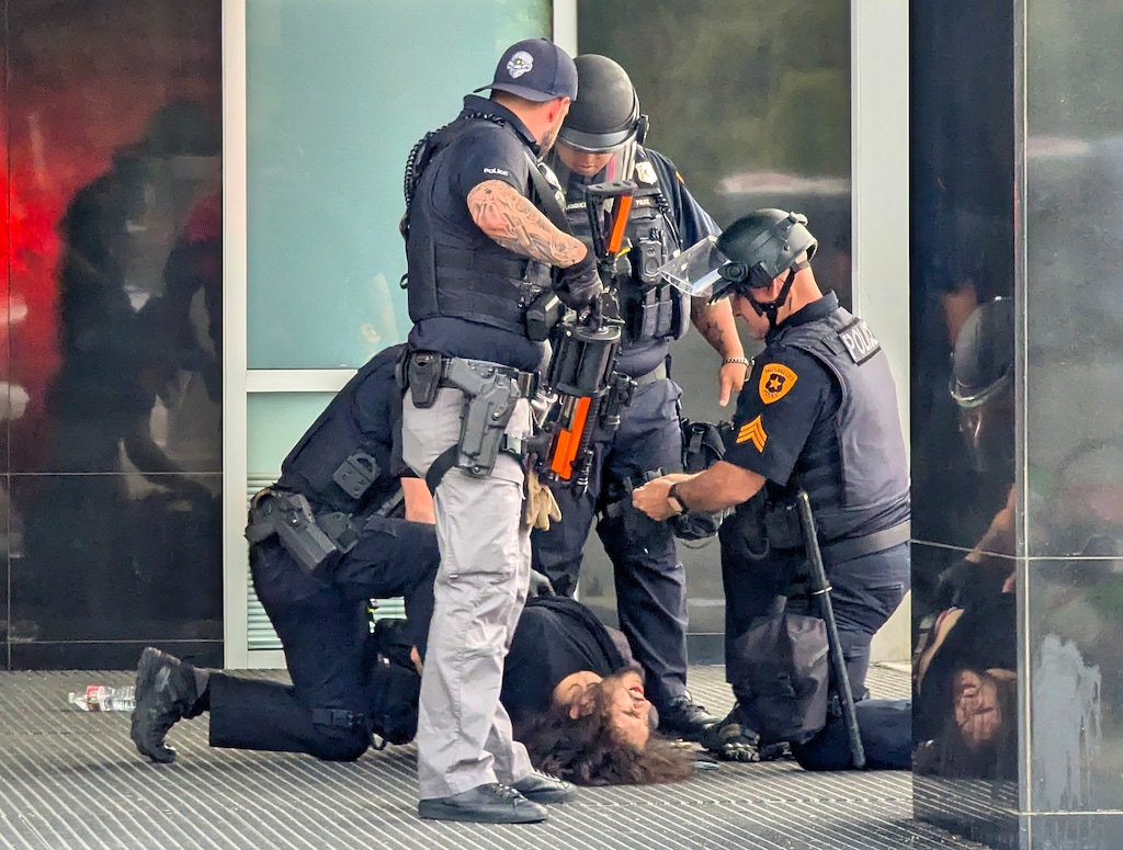 (Chad Thaxton) Arturo Gamboa, 24, is detained by Salt Lake City Police after a shooting during a march in Salt Lake City, Saturday, June 14, 2025.