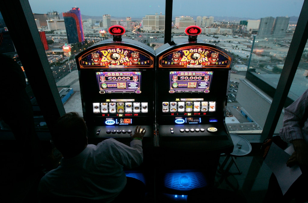 FILE - In this June 6, 2007 file photo, Bally Technologies slot machines are showcased at the Palms hotel-casino in Las Vegas. Scientific Games on Friday, Aug. 1, 2014 said it will pay about $3.3 billion to buy slot machine maker Bally Technologies in a cash deal that expands its casino management system portfolio. (AP Photo/Jae C. Hong, File)
