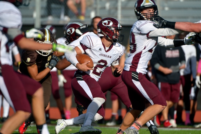 (Chris Detrick  |  The Salt Lake Tribune)  Jordan's Austin Kafentzis (2) runs the ball during the game at Davis High School Friday October 31, 2014.