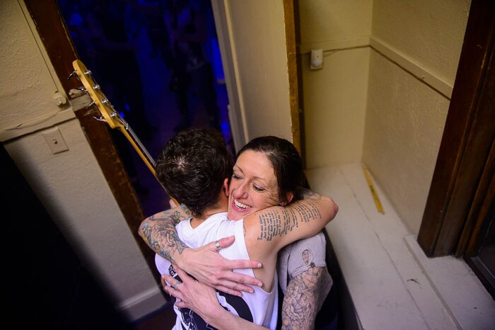 (Trent Nelson | The Salt Lake Tribune) Amy Stocks embraces a musician fresh off the stage at Rock Camp for Womyn's showcase Rock Camp for Womyn's showcase on Feb. 4. Campers learned how to play instruments, form bands, write songs, and perform live in concert — all in three days. It's a new program by the same group that does Rock and Roll Camp for Girls.