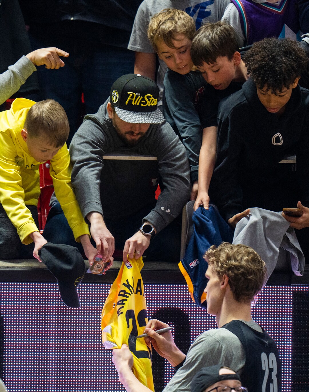 (Rick Egan | The Salt Lake Tribune) Lauri Markkanen signs autographs during the Western team All-Star Practice at the Jon M. Huntsman Center, on Saturday, Feb. 18, 2023.