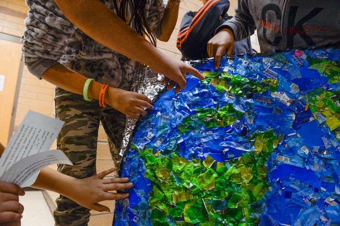 (Leah Hogsten | The Salt Lake Tribune) Students at Parkview Elementary have created a treasure with trash. Ten fifth graders in Cher Sten's extended learning program or ELP class, molded school and household plastic refuse into a mosaic to send the message: "Consume Less" to their classmates. The idea for the mural began after a discussion about global warming, climate issues, plastic pollution and its implications on earth.