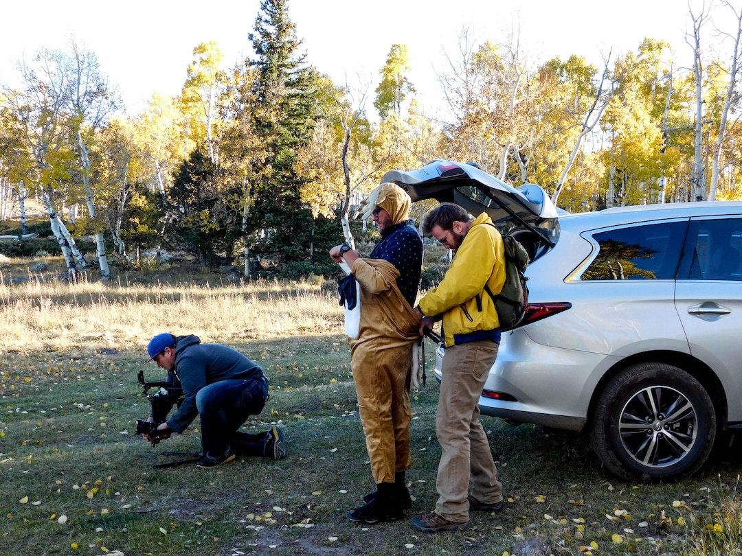 (Erin Alberty  |  The Salt Lake Tribune) Comedians Brad Einstein helps Kyle Niemer put on a deer costume to shoot comedy sketches about ecology — or "silly bits in the woods," as Einstein calls them — with videographer Dave Thomas on Oct. 5, 2017 at the Pando aspen clone in Sevier County.