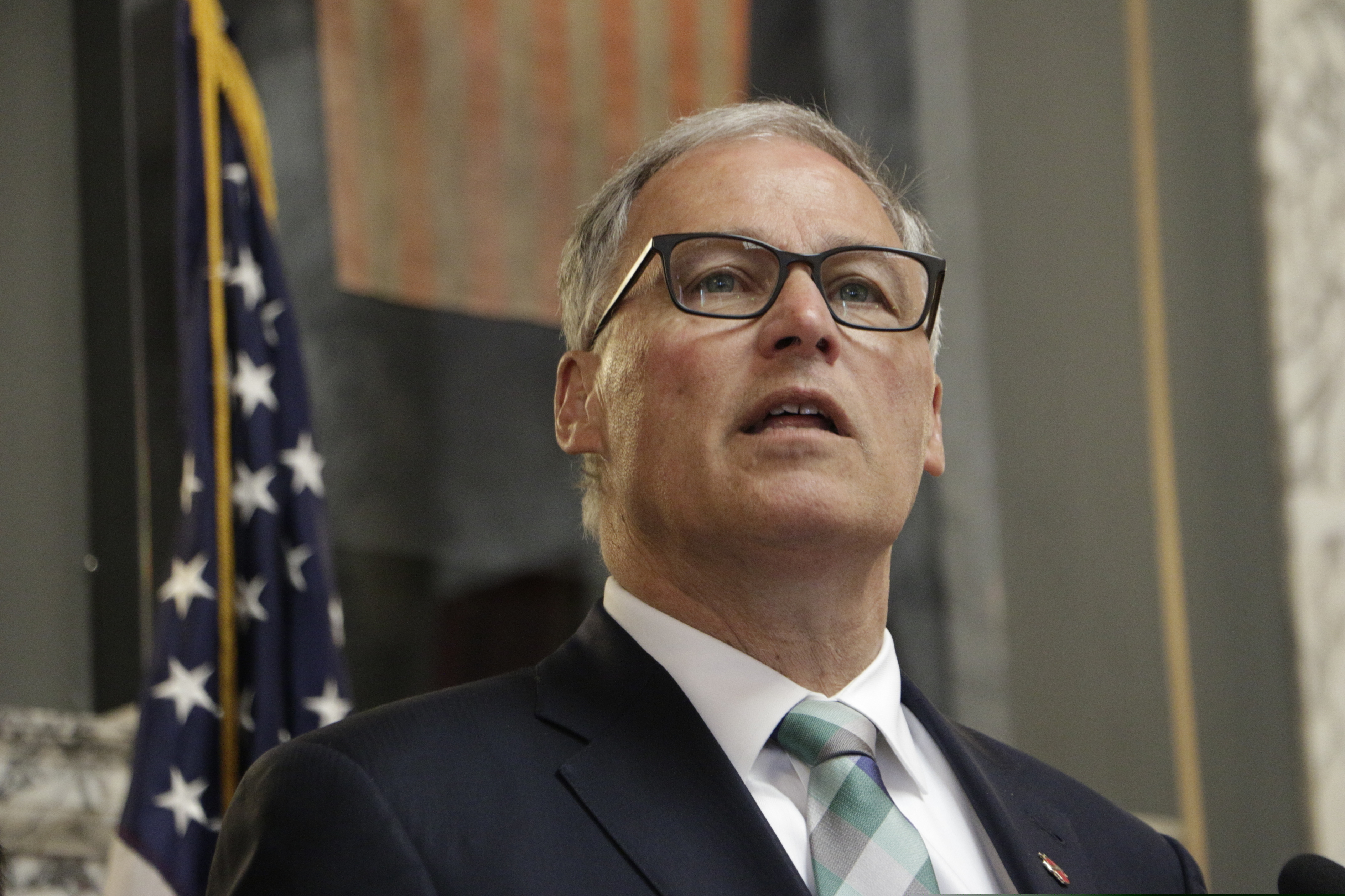 FILE - In this Monday, May 13, 2019, file photo, Washington Gov. Jay Inslee speaks in Olympia, Wash. Washington has become the latest West Coast state to enact broad sanctuary protections that restrict all local authorities from asking about people's immigration status. Inslee signed the measure Tuesday, May 21, 2019, implementing the new rules. (AP Photo/Rachel La Corte, File)