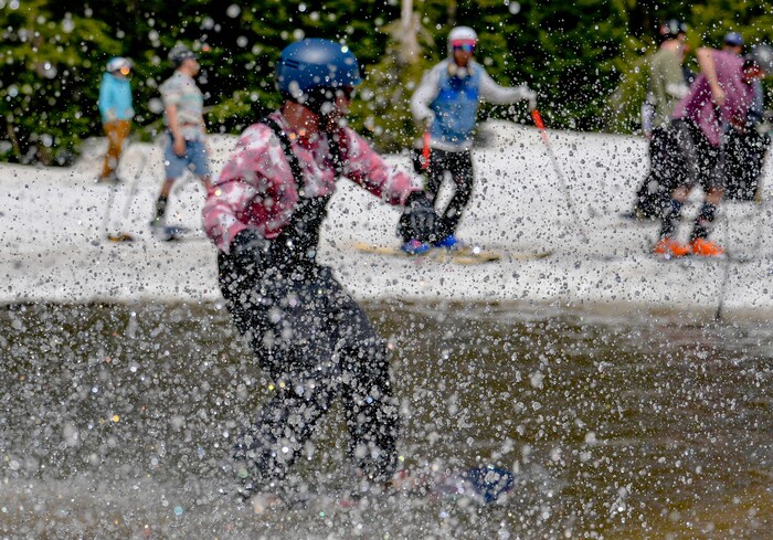 (Francisco Kjolseth  | The Salt Lake Tribune) A party atmosphere forms at the pond in Peruvian Gulch as Snowbird closes the book on the 2024-25 ski season on Monday, May 26, 2025. Snow and sun revelers took to the slushy slopes on Memorial Day as the resort was the last in the state to close.