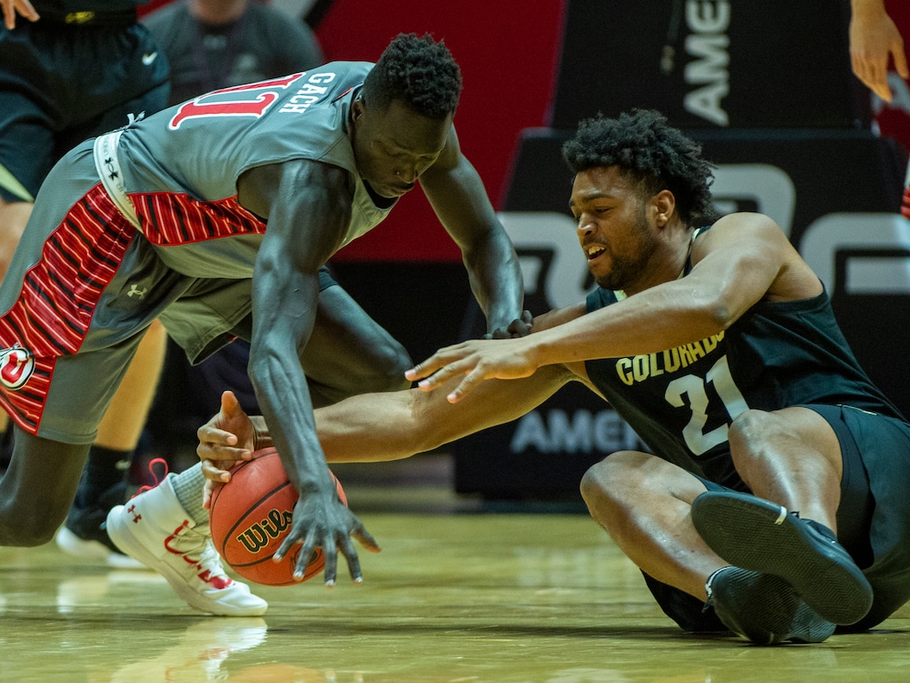 (Rick Egan  |  The Salt Lake Tribune)     Utah Utes guard Both Gach (11) goes for a loose ball along with Colorado Buffaloes forward Evan Battey (21), in Pac-12 basketball action between the Utah Utes and the Colorado Buffaloes at the Jon M. Huntsman Center, Sunday, Jan. 20, 2019.